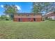 The backyard of a two story home featuring a grass lawn and small sitting area at 2468 Dresden Ne Dr, Atlanta, GA 30341