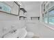 Bright bathroom features white fixtures, ample natural light and shelving for storage and decor at 2468 Dresden Ne Dr, Atlanta, GA 30341
