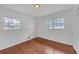 Bright bedroom with hardwood floors, two windows, and a built-in closet providing a cozy retreat at 2468 Dresden Ne Dr, Atlanta, GA 30341
