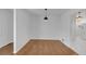 Spacious dining room with hardwood floors, minimalist lighting, and white walls for versatile decor options at 2468 Dresden Ne Dr, Atlanta, GA 30341