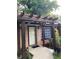 Close-up of the front entrance with a stylish pergola and a well-manicured garden bed at 2468 Dresden Ne Dr, Atlanta, GA 30341