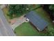 View of the home from above, featuring the street, sidewalk, and large surrounding trees at 2468 Dresden Ne Dr, Atlanta, GA 30341