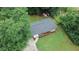 Aerial view of a well maintained lawn with a home, surrounded by large trees on the property at 2468 Dresden Ne Dr, Atlanta, GA 30341