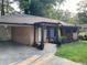 Charming single-story home with a brick facade, pergola entrance and a well-maintained lawn at 2468 Dresden Ne Dr, Atlanta, GA 30341