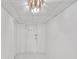 Bright hallway with a decorative light fixture and white door at 2468 Dresden Ne Dr, Atlanta, GA 30341