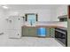 A well-lit kitchen boasts butcher block countertops, modern appliances, and sleek white and green cabinetry at 2468 Dresden Ne Dr, Atlanta, GA 30341