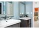 Dual sink bathroom featuring modern vanities, mirrors, tile accents, and modern fixtures at 2917 Ashebrooke Ne Dr, Marietta, GA 30068