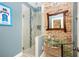 Modern bathroom with glass shower, brick wall, and stylish vessel sink at 2917 Ashebrooke Ne Dr, Marietta, GA 30068