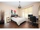 Bright bedroom featuring hardwood floors, a comfortable bed, stylish decor and natural light from the large window at 2917 Ashebrooke Ne Dr, Marietta, GA 30068