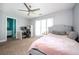 Cozy bedroom featuring a ceiling fan, tufted headboard, desk, and natural light from the window at 2917 Ashebrooke Ne Dr, Marietta, GA 30068