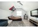 Cozy bedroom featuring a modern futon bed, mini fridge, TV, and unique decor at 2917 Ashebrooke Ne Dr, Marietta, GA 30068