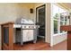 Outdoor grill with stainless steel accents on wooden deck, next to wall with large windows at 2917 Ashebrooke Ne Dr, Marietta, GA 30068