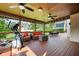 Outdoor deck featuring an exercise machine, comfortable seating, ceiling fans, and a view of the backyard at 2917 Ashebrooke Ne Dr, Marietta, GA 30068