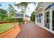 Wooden deck with black railing, grass and greenery beyond, along with a partial view of the home's exterior at 2917 Ashebrooke Ne Dr, Marietta, GA 30068