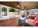 Comfortable outdoor deck featuring an exercise machine, comfortable seating, ceiling fans, and a view of the backyard at 2917 Ashebrooke Ne Dr, Marietta, GA 30068