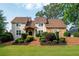 Charming home featuring a blend of stucco and stone facade, complemented by a well-manicured lawn and landscape at 2917 Ashebrooke Ne Dr, Marietta, GA 30068