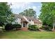 View of the charming home featuring a blend of stucco and stone facade, complemented by a well-manicured lawn at 2917 Ashebrooke Ne Dr, Marietta, GA 30068