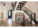 Elegant foyer showcasing hardwood floors, an ornate staircase with wrought iron details, and a striking front door at 2917 Ashebrooke Ne Dr, Marietta, GA 30068