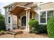 Charming front entrance featuring a covered porch with stone accents, decorative columns, and an iron-detailed front door at 2917 Ashebrooke Ne Dr, Marietta, GA 30068