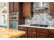 Gourmet kitchen showcasing stainless steel appliances, gas range, and decorative backsplash at 2917 Ashebrooke Ne Dr, Marietta, GA 30068