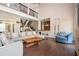Bright living room featuring vaulted ceilings, a brick fireplace, and a built-in bar with access to the foyer at 2917 Ashebrooke Ne Dr, Marietta, GA 30068