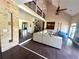 Open-concept living room features a soaring ceiling, dark floors, brick accents, and access to multiple rooms at 2917 Ashebrooke Ne Dr, Marietta, GA 30068