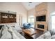 Bright living room featuring vaulted ceilings, a brick fireplace, a built-in bar and french doors to the back porch at 2917 Ashebrooke Ne Dr, Marietta, GA 30068