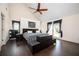 Main bedroom featuring high ceilings, hardwood floors, a king sized bed, and access to the outdoor deck at 2917 Ashebrooke Ne Dr, Marietta, GA 30068