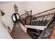 Staircase with wooden banister and black decorative iron, dark hardwood flooring, and an arched front door at 2917 Ashebrooke Ne Dr, Marietta, GA 30068