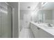 Bright bathroom featuring double sinks, a glass-enclosed shower, and white cabinetry at 3150 Woodwalk Se Dr # 2204, Atlanta, GA 30339