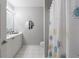 This bathroom is bright and airy with a shower curtain, vanity and large mirror at 3150 Woodwalk Se Dr # 2204, Atlanta, GA 30339