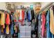Walk-in closet with organized storage solutions and a variety of hanging clothes at 3150 Woodwalk Se Dr # 2204, Atlanta, GA 30339