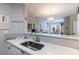 Bright kitchen with quartz countertops, stainless steel sink, white cabinets, and hardwood floors at 3150 Woodwalk Se Dr # 2204, Atlanta, GA 30339