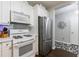Updated kitchen featuring a stainless steel refrigerator, white cabinets, and modern lighting fixtures at 3150 Woodwalk Se Dr # 2204, Atlanta, GA 30339