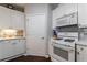 Bright kitchen featuring white appliances, white cabinets, and quartz countertops at 3150 Woodwalk Se Dr # 2204, Atlanta, GA 30339