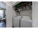 Efficient laundry closet with a stacked washer and dryer, optimizing space and convenience at 3150 Woodwalk Se Dr # 2204, Atlanta, GA 30339