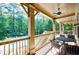 Covered patio seating area with ceiling fan overlooks the community pool and lush trees at 3150 Woodwalk Se Dr # 2204, Atlanta, GA 30339