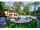 Community pool area with tables, chairs, and lounge furniture on a sunny day at 3150 Woodwalk Se Dr # 2204, Atlanta, GA 30339