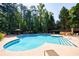 Inviting community swimming pool surrounded by lush trees and lounge chairs, creating a relaxing atmosphere at 3150 Woodwalk Se Dr # 2204, Atlanta, GA 30339