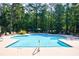 Refreshing community swimming pool surrounded by lounge chairs and lush greenery, ideal for relaxation at 3150 Woodwalk Se Dr # 2204, Atlanta, GA 30339