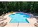 Inviting community swimming pool with lounge chairs, lush trees, and a calm atmosphere at 3150 Woodwalk Se Dr # 2204, Atlanta, GA 30339