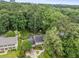Aerial view of home, and large treed lot, with nearby commercial development at 3541 Castlehill Ct, Tucker, GA 30084
