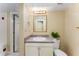 Well-lit bathroom with vanity, sink, and decorative mirror at 3541 Castlehill Ct, Tucker, GA 30084