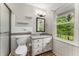 A full bathroom with tiled walls, pedestal sink, shower and natural light at 3541 Castlehill Ct, Tucker, GA 30084