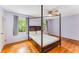 A well-lit bedroom with hardwood floors and ample natural light from the two windows at 3541 Castlehill Ct, Tucker, GA 30084