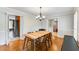 Dining room with wood floors, and neutral color paint, with views to kitchen and outdoors at 3541 Castlehill Ct, Tucker, GA 30084