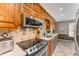Traditional wood kitchen with stainless steel microwave, stove, dishwasher, tiled backsplash and large window at 3541 Castlehill Ct, Tucker, GA 30084