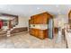 Open concept kitchen with tile floors, wood cabinets, and stainless steel dishwasher at 3541 Castlehill Ct, Tucker, GA 30084