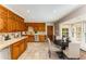 Traditional eat-in kitchen with custom wood cabinets, stainless steel appliances, and large bay window at 3541 Castlehill Ct, Tucker, GA 30084