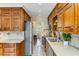Wood-paneled kitchen featuring tile backsplash, ample cabinet space and stainless steel appliances at 3541 Castlehill Ct, Tucker, GA 30084